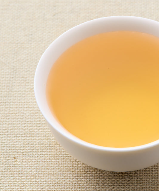 assam white tea liquid in a cup