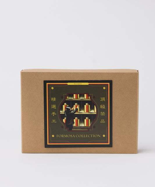 A brown gift box labeled Formosa Collection with a decorative design of a person selecting tea jars from a shelf, accented with gold and Chinese characters.