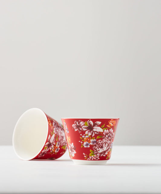 Red floral cups, one upright and one lying on its side