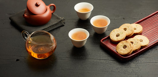 tea in teacups and linzer cookies on a plate