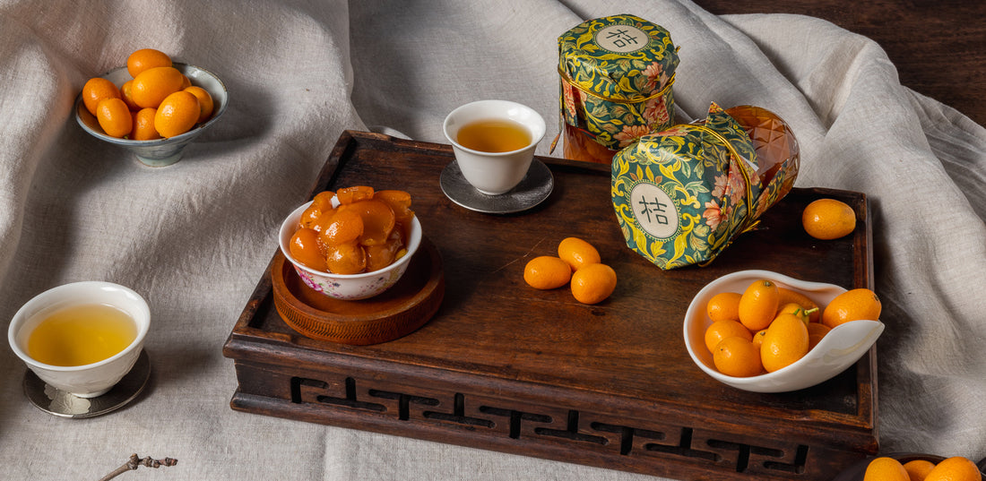 Tea set with kumquats and decorative packaging.