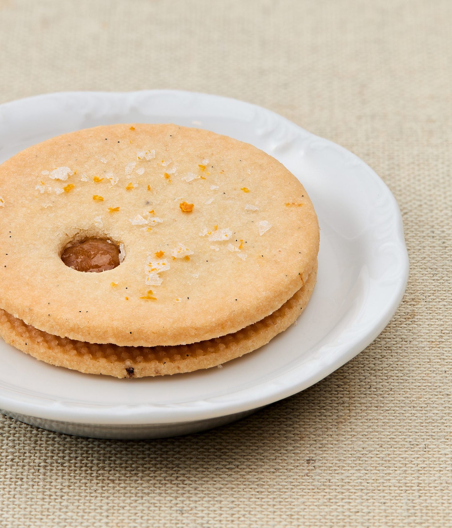 linzer cookie with a central hole on a white plate