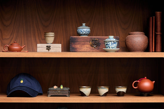 Wooden shelves with various ceramic items and a cap
