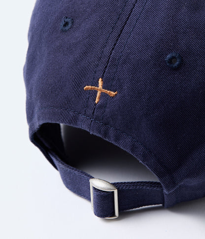 Navy blue cap with a brown embroidered logo on the back, on a white background