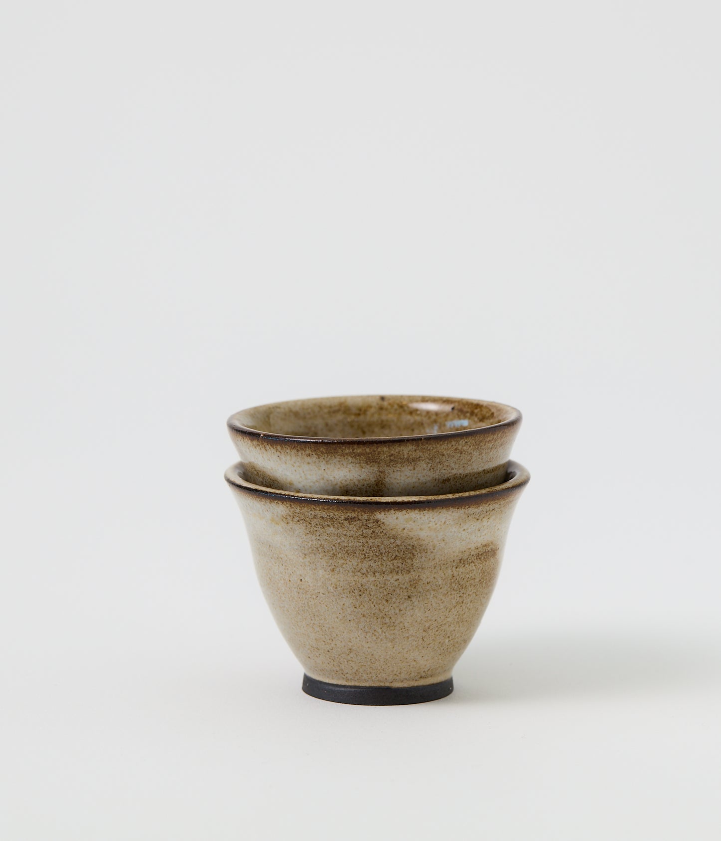 Two ceramic bowls stacked on a white background