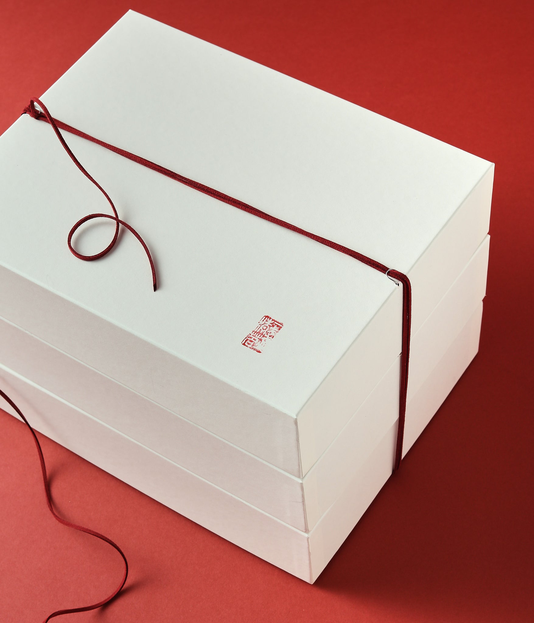 Lunar New Year white gift box with red cord closure