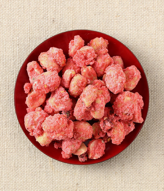 Top-down view of red candied peanuts.