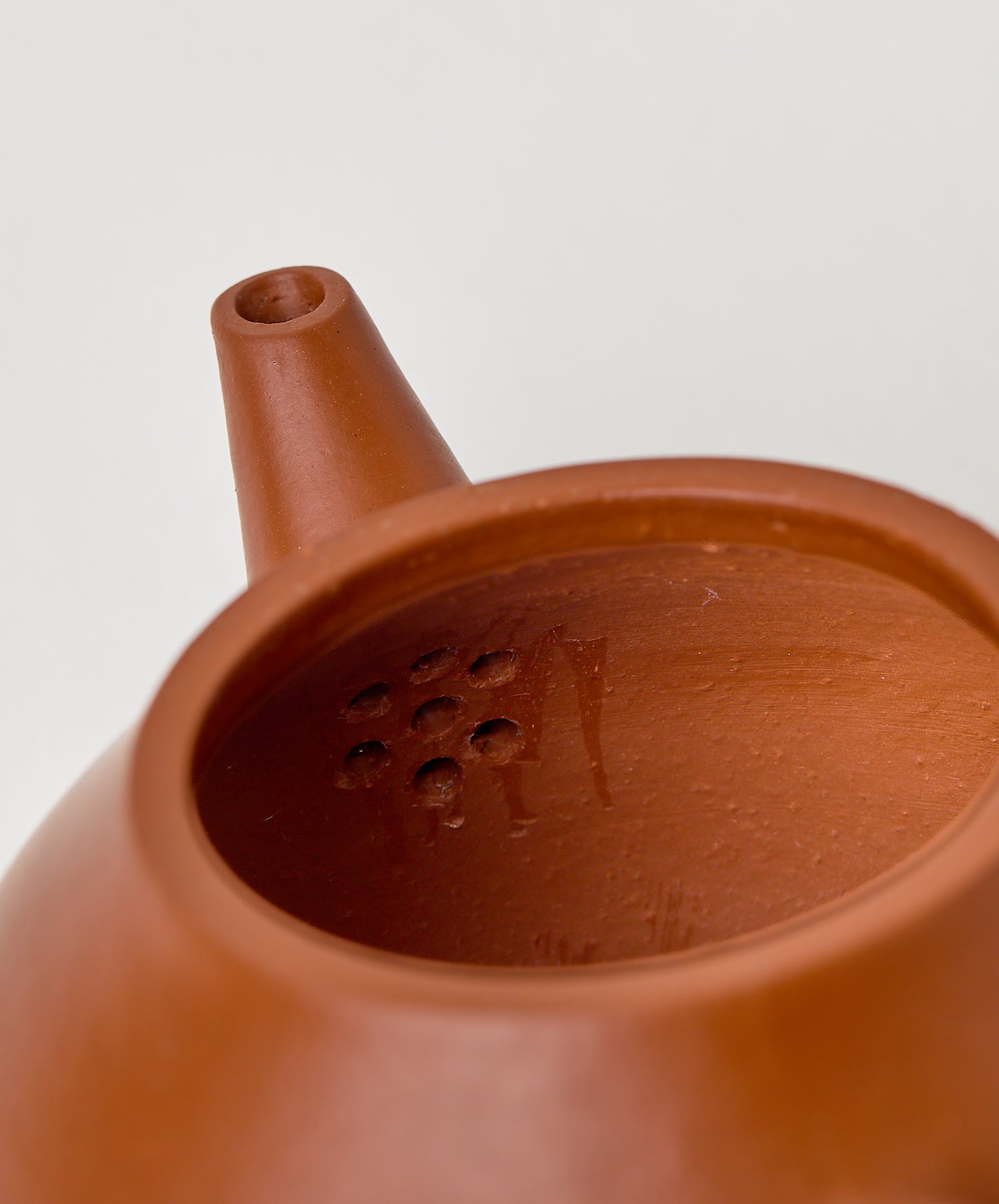 Interior view of the Professor Yixing Clay teapot showing strainer holes.