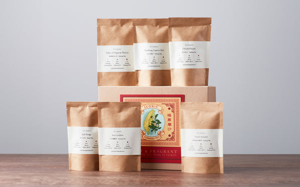 A collection of six brown tea packets arranged around an elegant red and gold tea box labeled Iconic Formosa Tea.