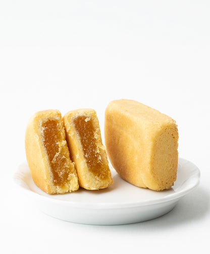 Close-up of pineapple cake cut in half on a plate