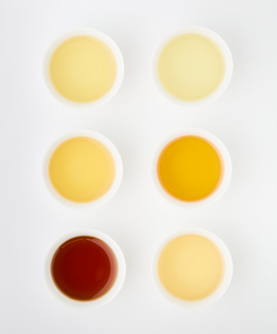 Different brewed teas in white bowls