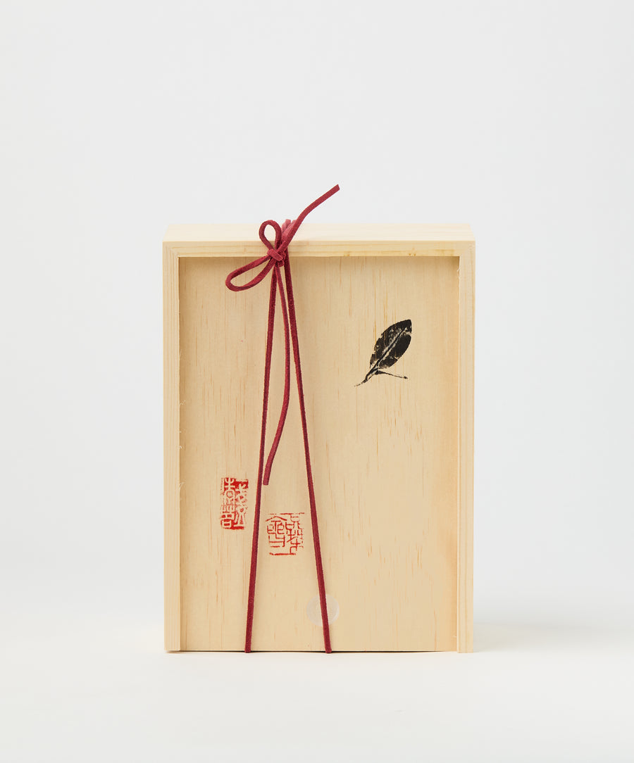 Wooden box with red ribbon and Chinese stamps